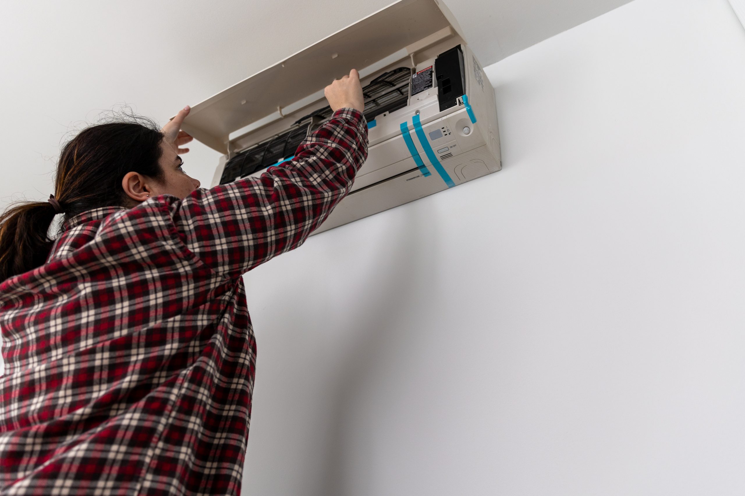 get-noticed_card Caucasian female installing a split HVAC unit