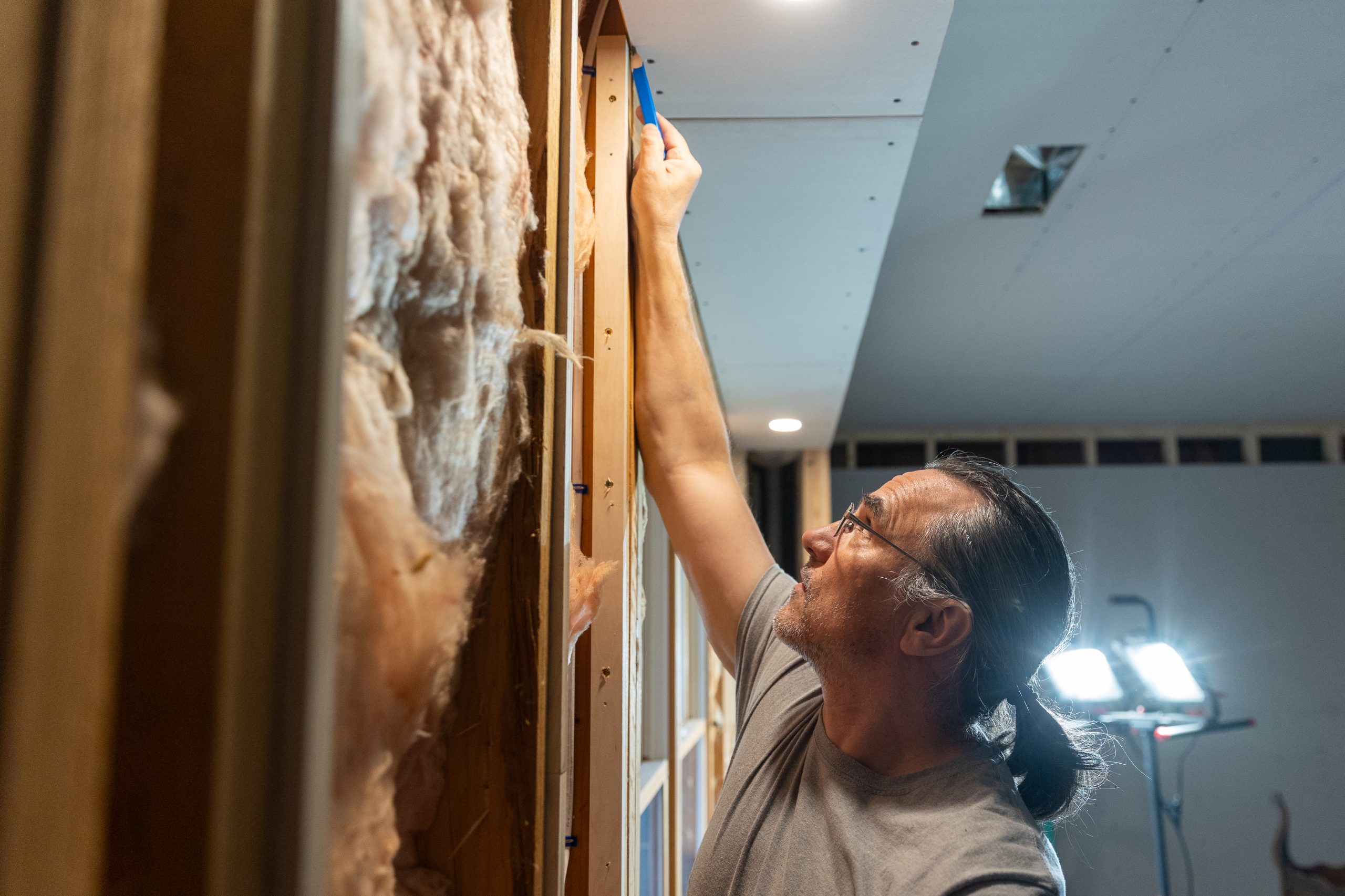 show-off-your-skills_card Caucasian male measuring ceiling to run electrical wiring